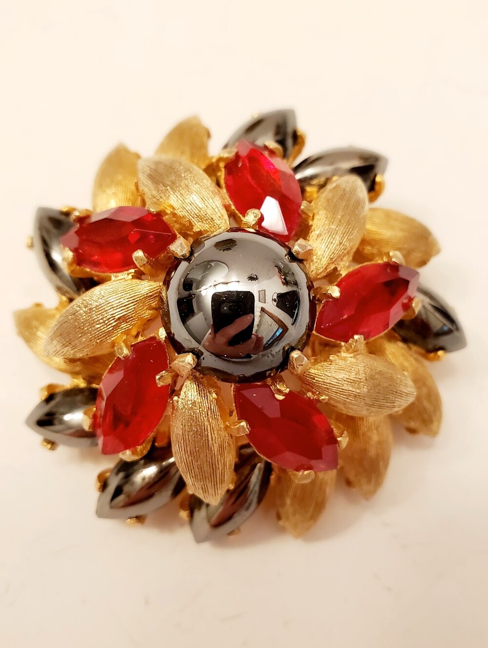 BENEDIKT NY Gold-Tone Flower Brooch with Red Rhinestones and Hematite Accents